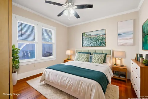 a bedroom with a bed a dresser and a window