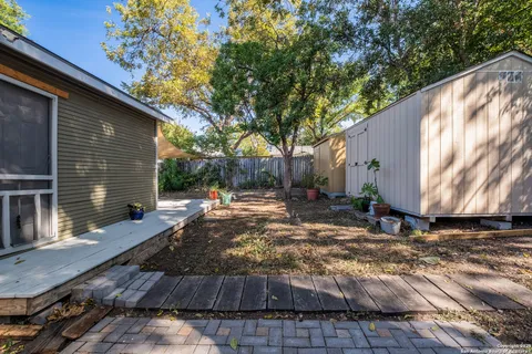 a backyard of a house with table and chairs