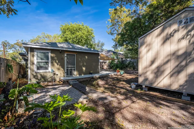 a view of a chair and table in the backyard