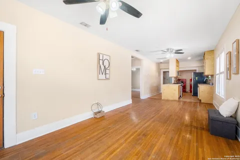 a view of a living room hardwood and kitchen