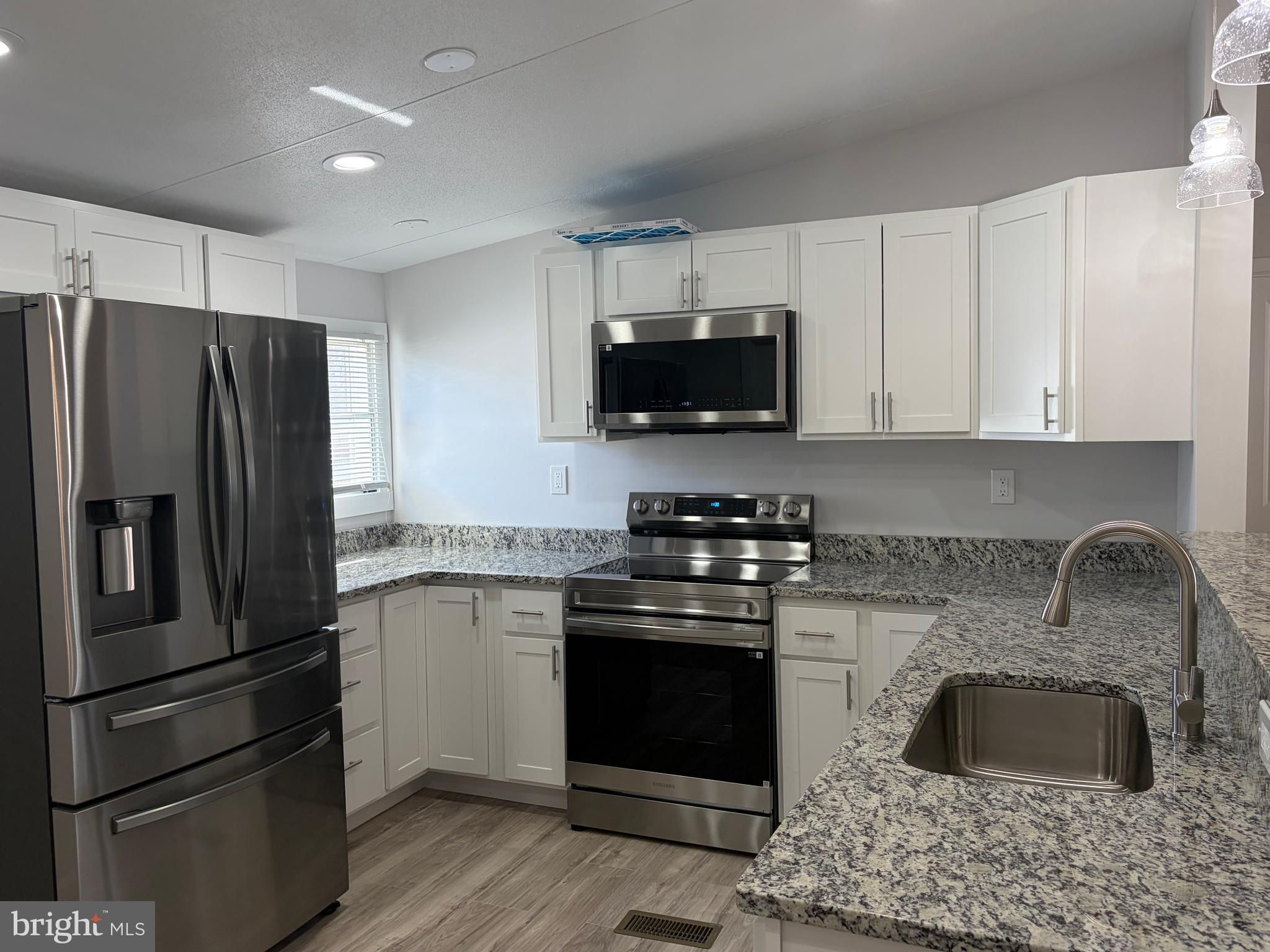 7 Roseview Road Dundalk, MD 21222 - Photo 3 of 13 a kitchen with stainless steel appliances granite countertop a stove a refrigerator and a sink