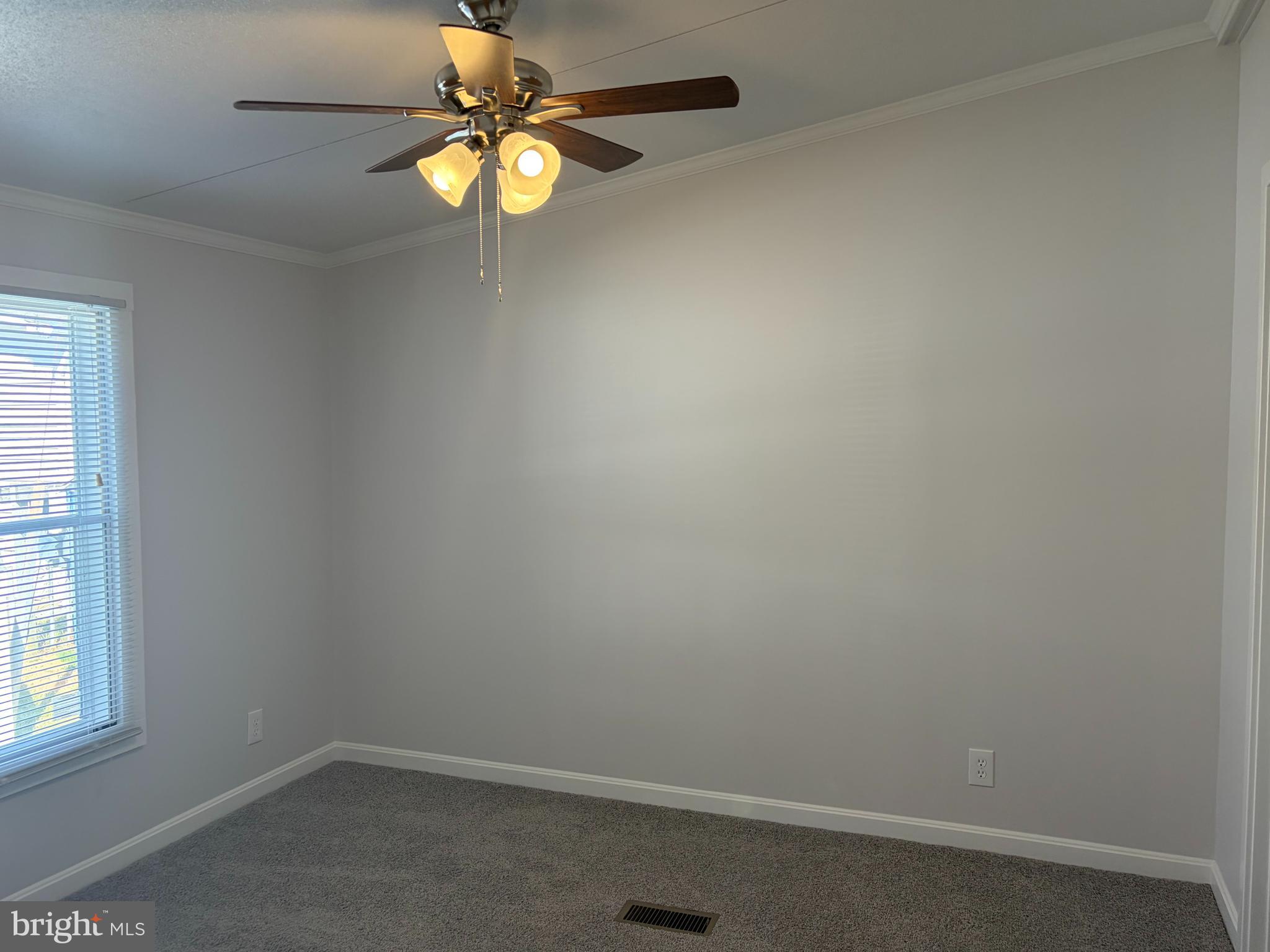7 Roseview Road Dundalk, MD 21222 - Photo 5 of 13 an empty room with a window and a fan