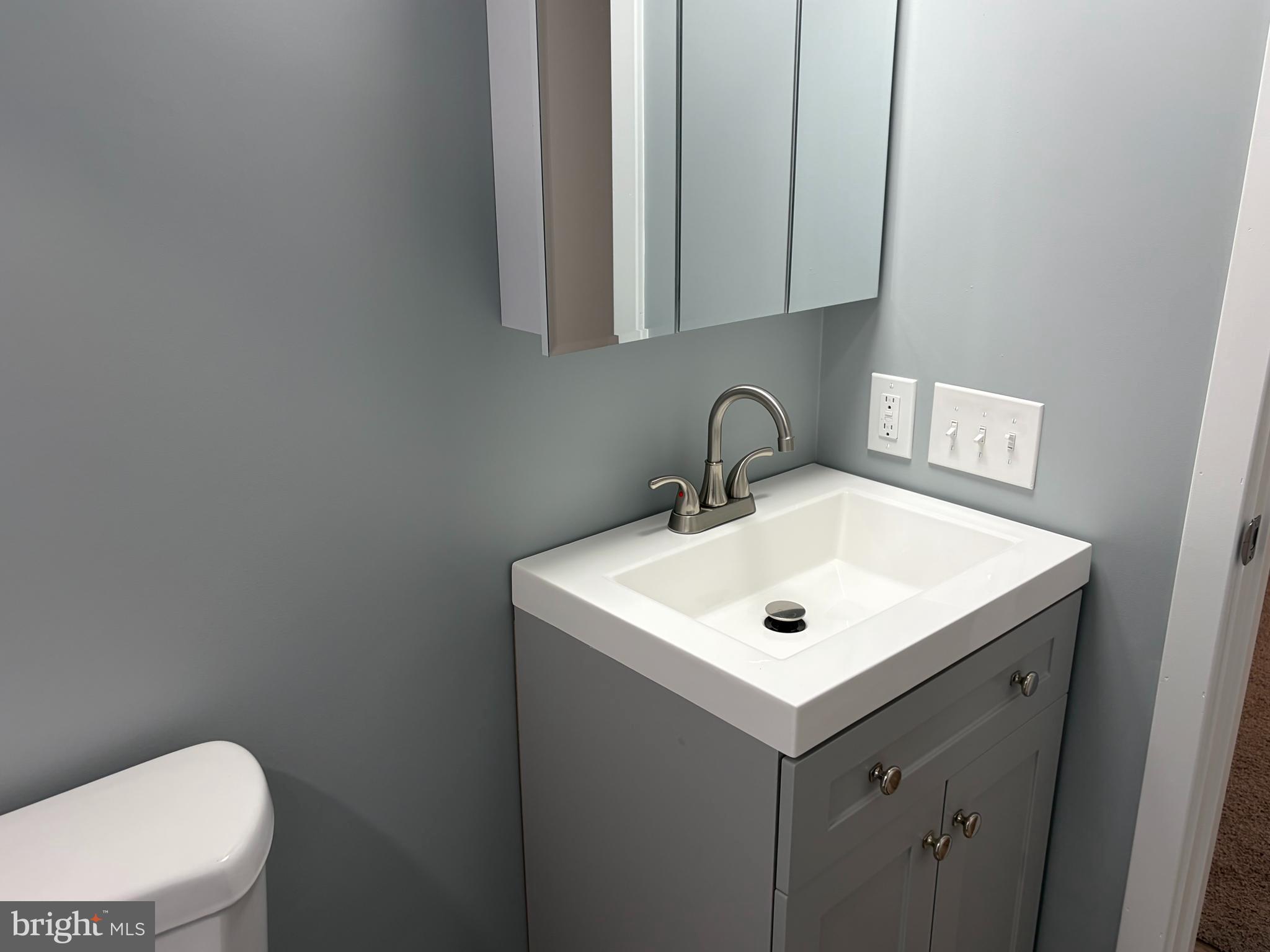 7 Roseview Road Dundalk, MD 21222 - Photo 9 of 13 a bathroom with a toilet sink and mirror