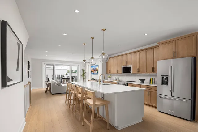 a kitchen with kitchen island white cabinets and stainless steel appliances