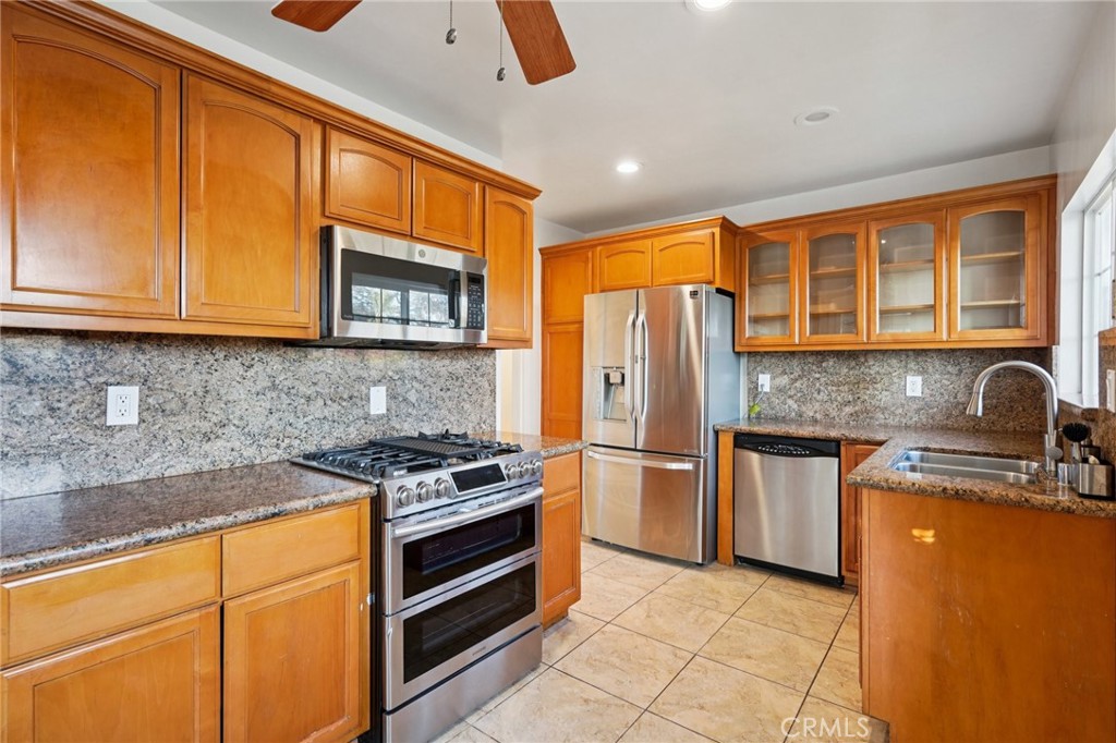 732 East Charron Place Compton, CA 90220 - Photo 12 of 24 a kitchen with stainless steel appliances granite countertop a stove refrigerator sink and cabinets