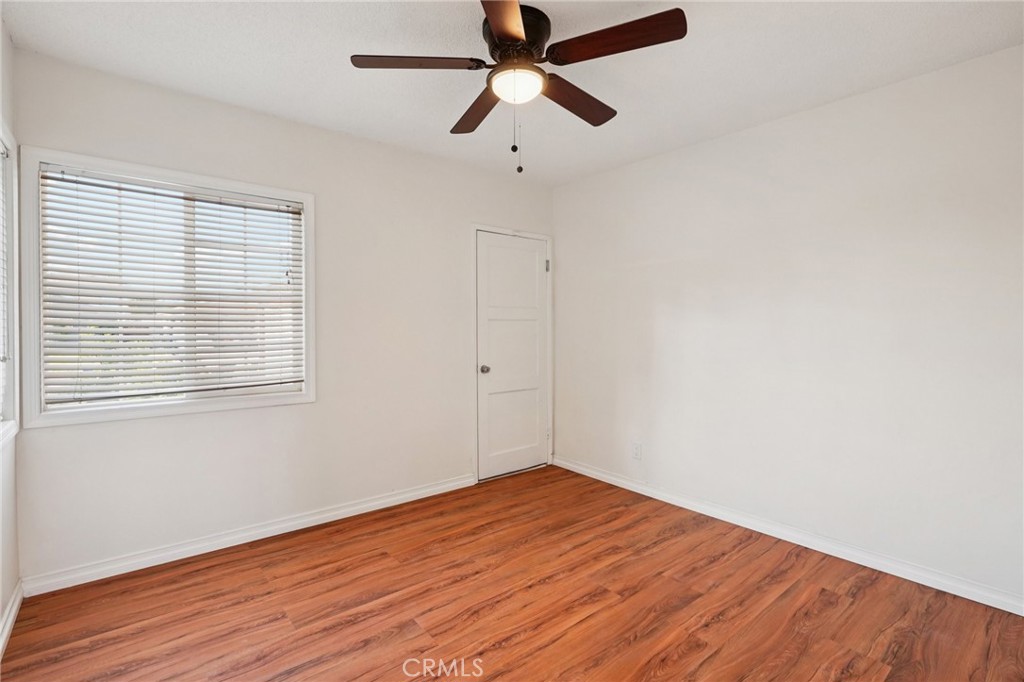 732 East Charron Place Compton, CA 90220 - Photo 13 of 24 a view of empty room with wooden floor and fan