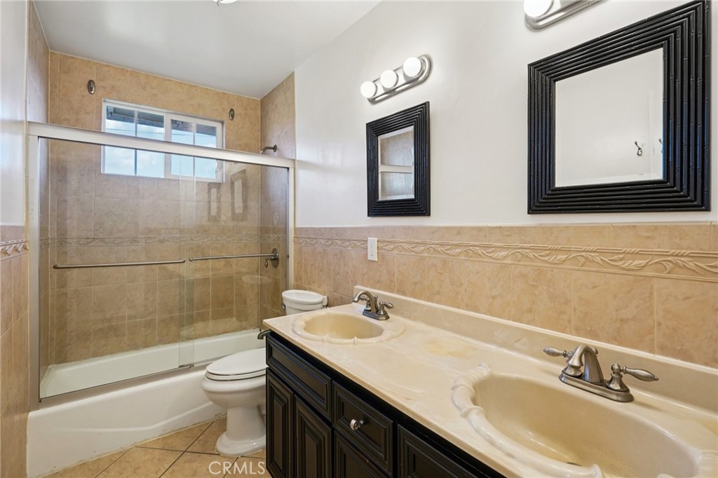 732 East Charron Place Compton, CA 90220 - Photo 16 of 24 a bathroom with a sink a toilet and shower