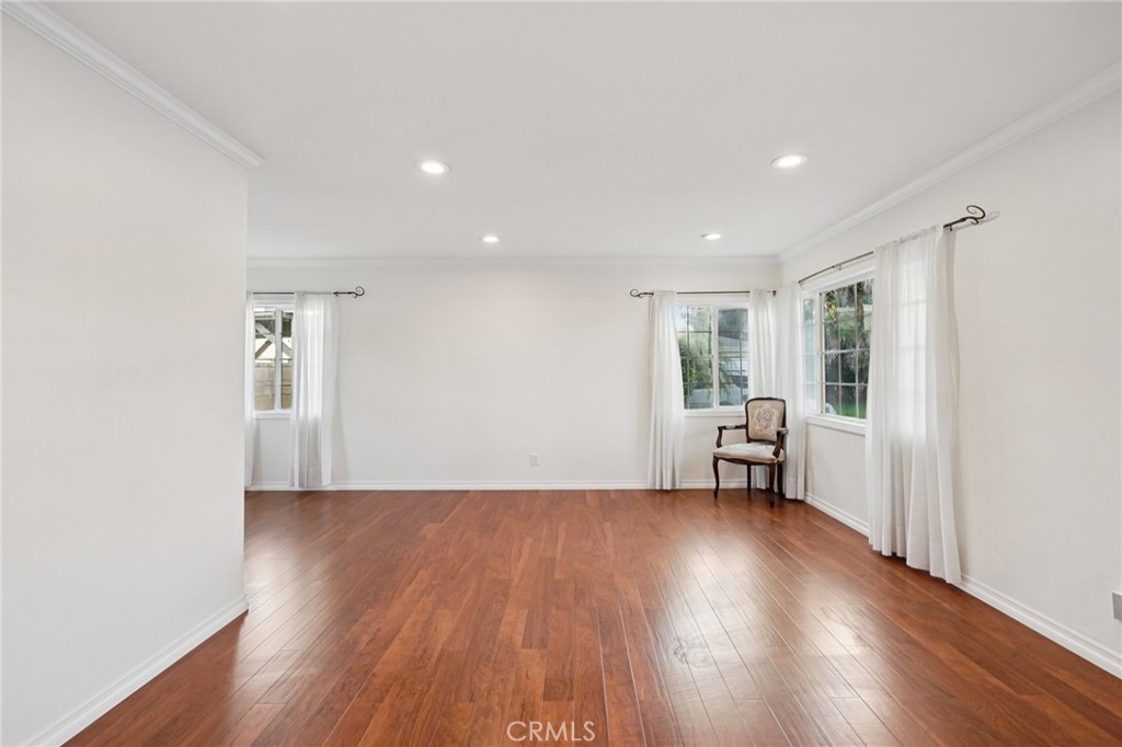 732 East Charron Place Compton, CA 90220 - Photo 3 of 24 a view of an empty room with wooden floor and a window