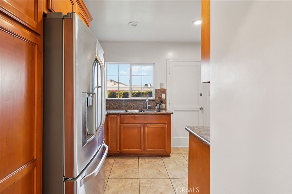 732 East Charron Place Compton, CA 90220 - Photo 8 of 24 a kitchen with stainless steel appliances granite countertop a refrigerator and a sink