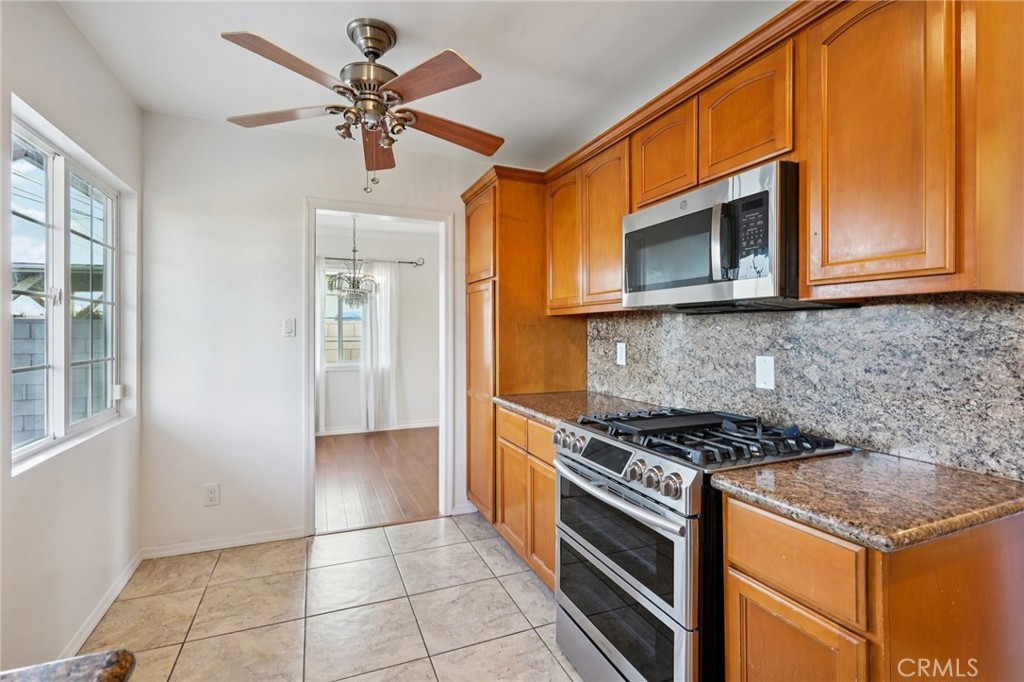 732 East Charron Place Compton, CA 90220 - Photo 10 of 24 a kitchen with stainless steel appliances granite countertop a stove and a microwave