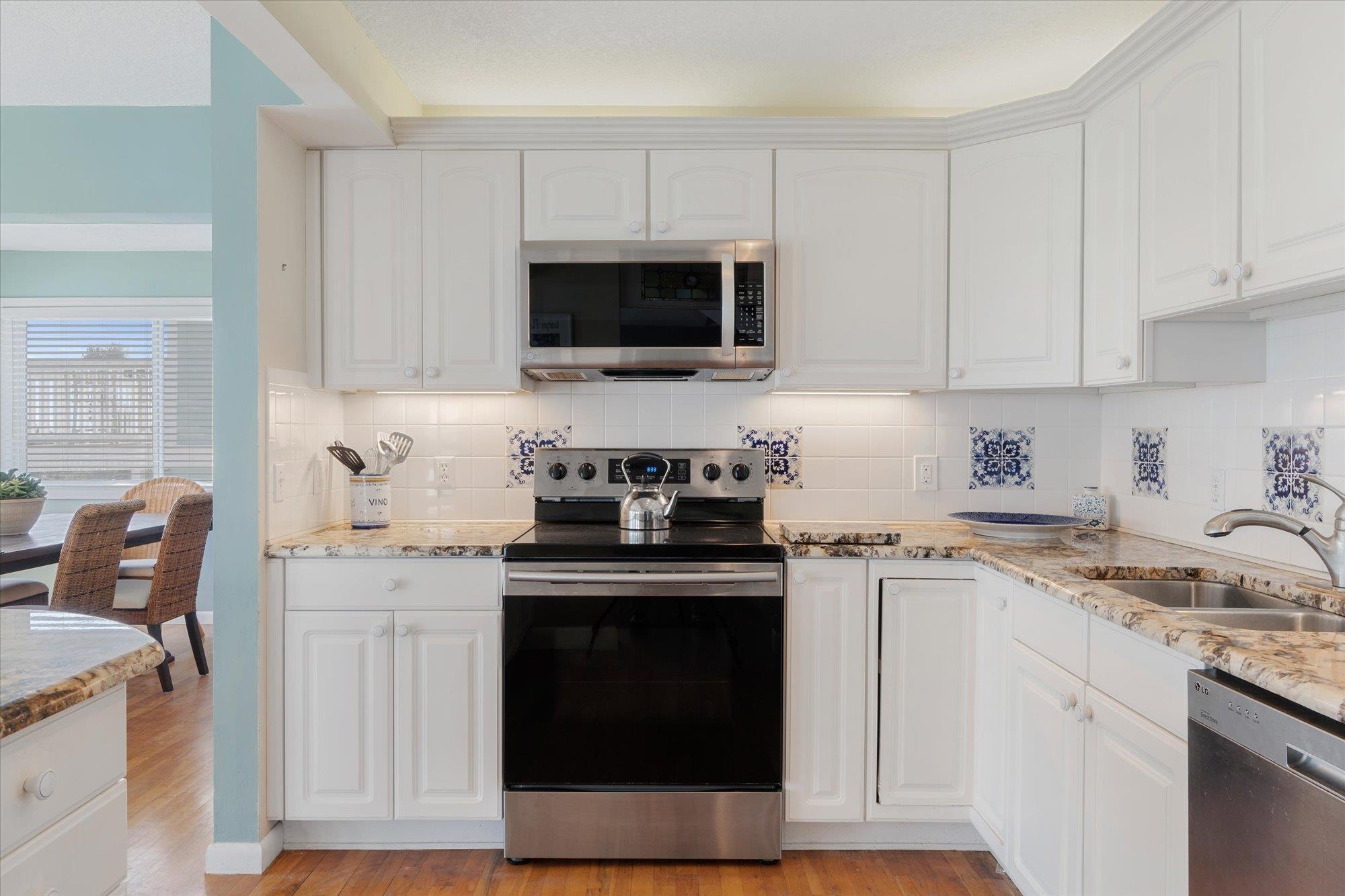 5512 Atlantic View St. Augustine, FL 32080 - Photo 15 of 77 Kitchen with stainless steel appliances and white cabinetry