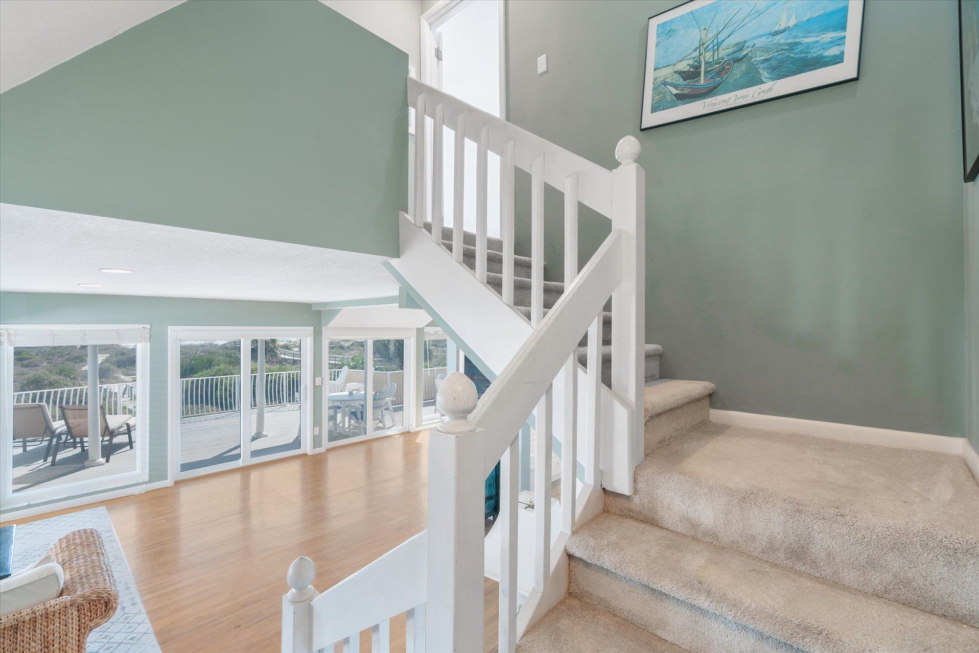 5512 Atlantic View St. Augustine, FL 32080 - Photo 20 of 77 Stairway featuring a high ceiling and wood finished floors