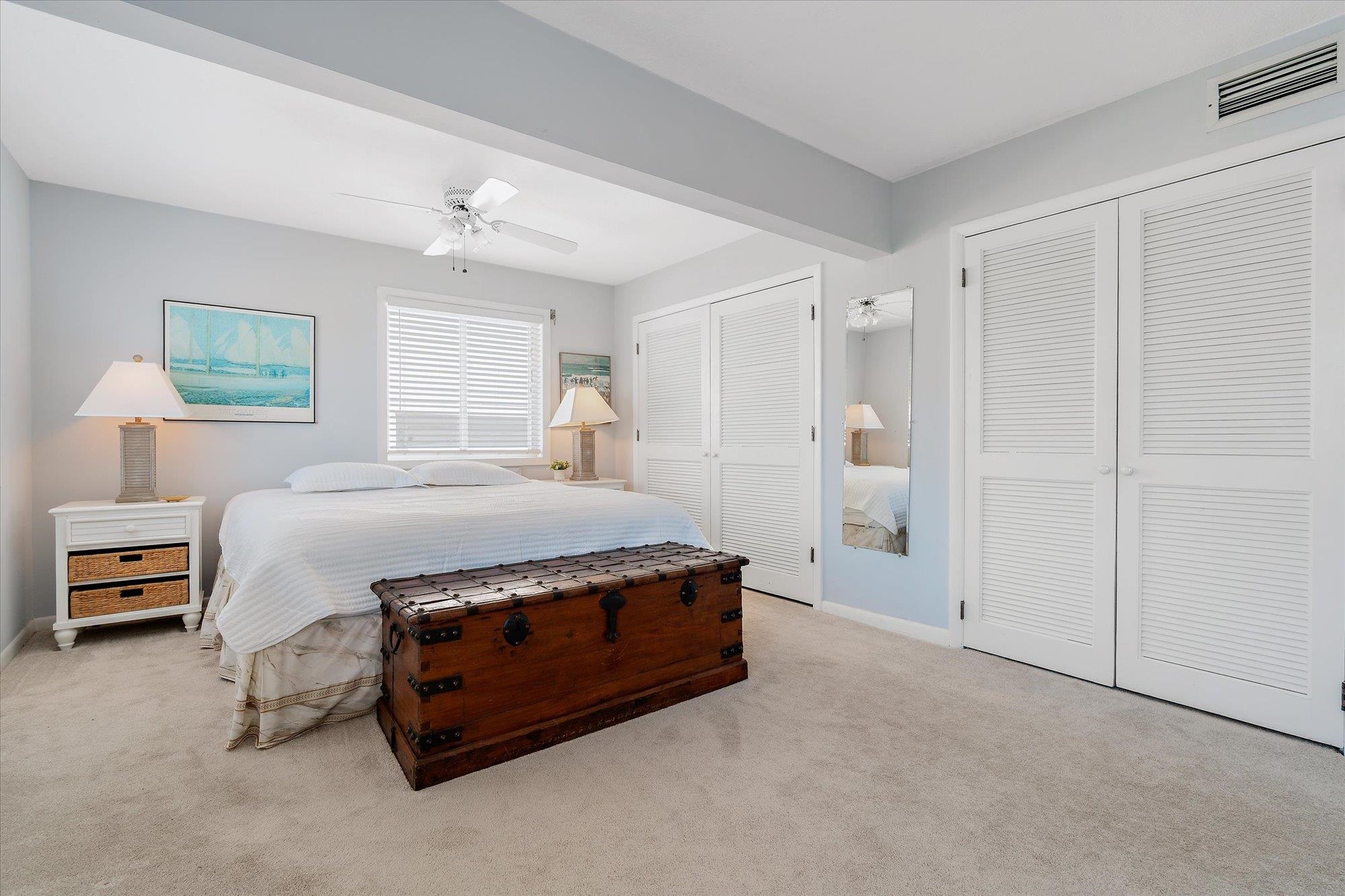 5512 Atlantic View St. Augustine, FL 32080 - Photo 22 of 77 Bedroom featuring multiple closets, light carpet, and a ceiling fan