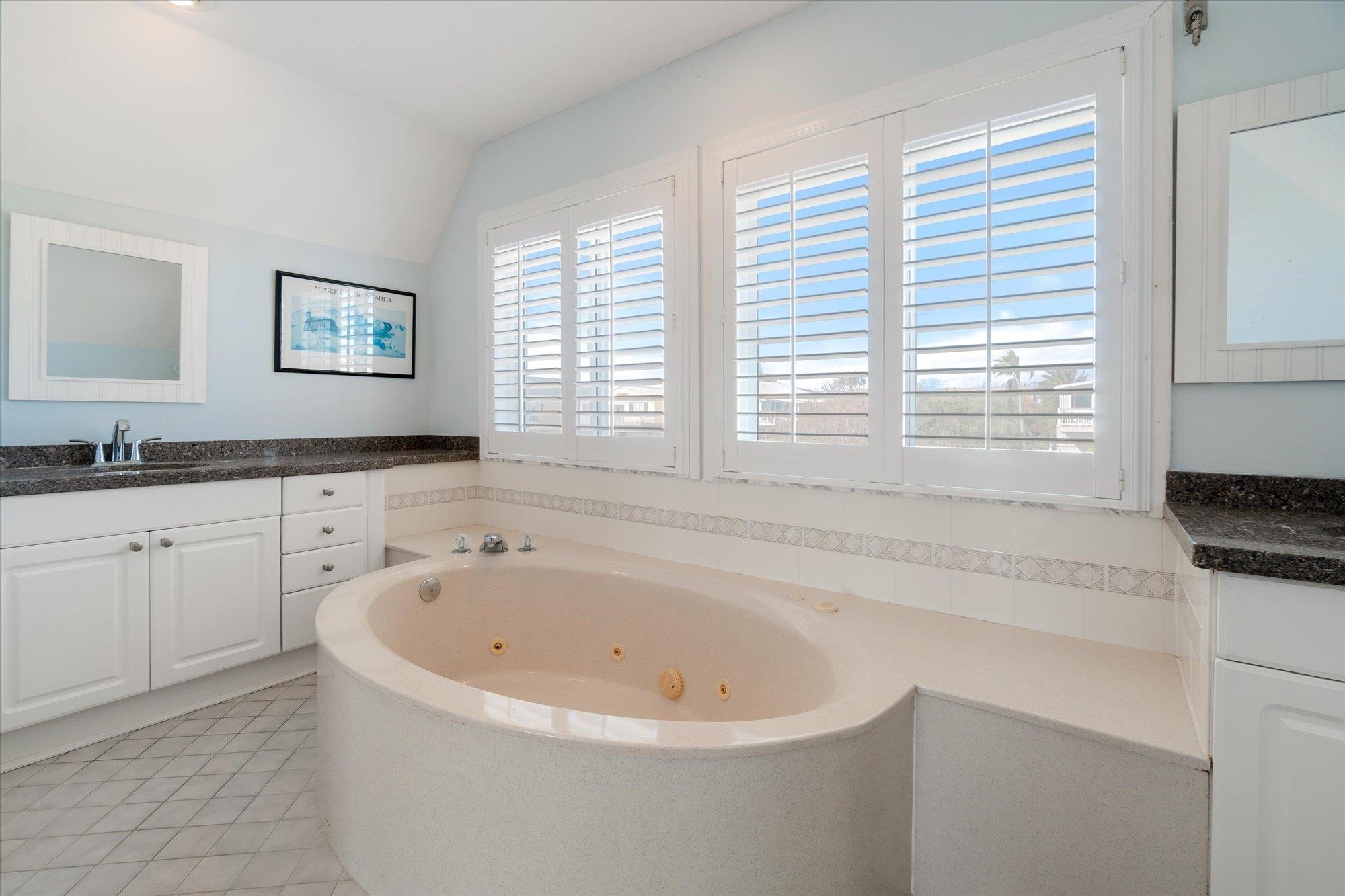 5512 Atlantic View St. Augustine, FL 32080 - Photo 23 of 77 Bathroom featuring vanity, a jetted tub, light tile patterned floors, and vaulted ceiling