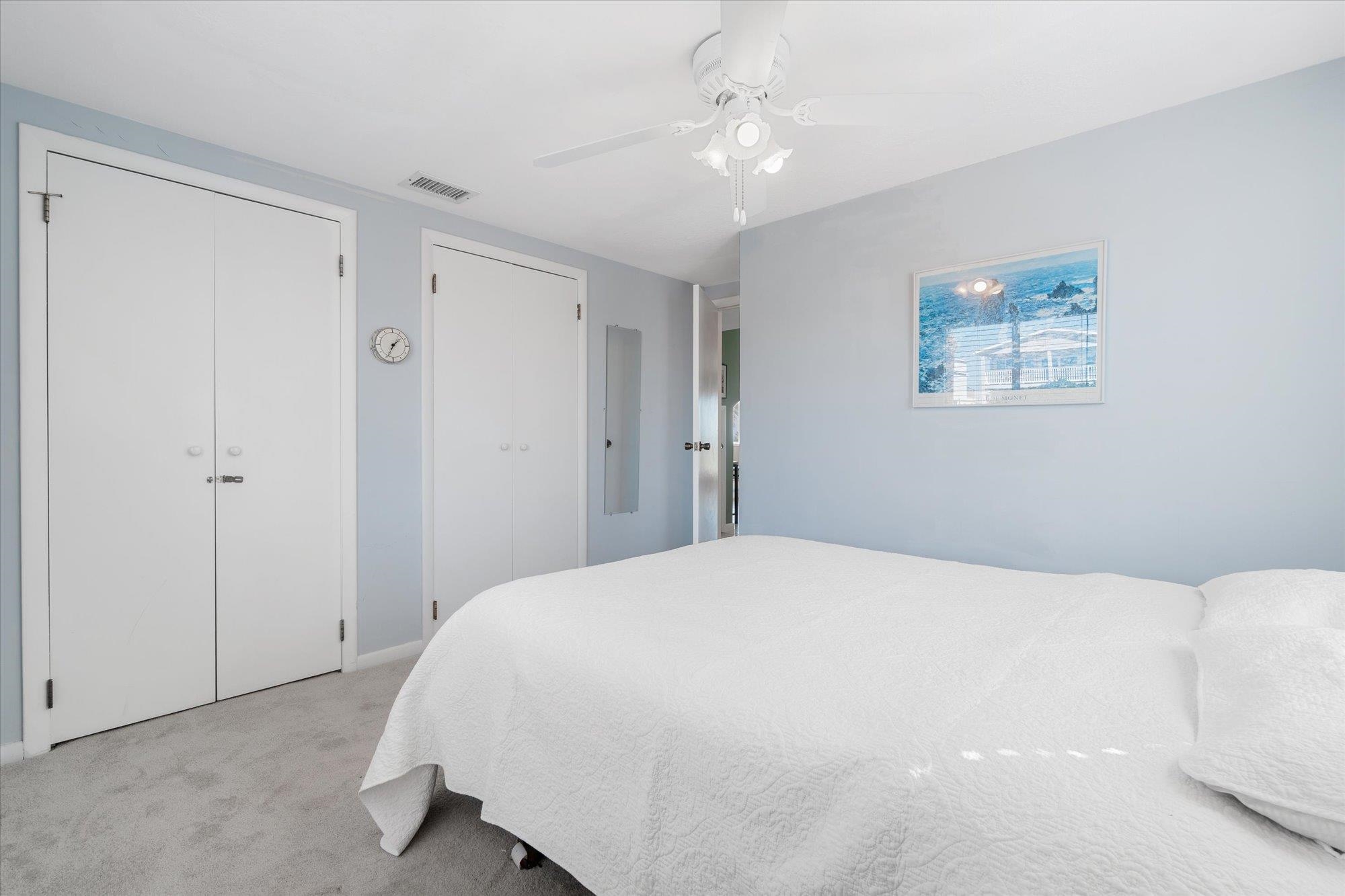 5512 Atlantic View St. Augustine, FL 32080 - Photo 31 of 77 Bedroom with multiple closets, light carpet, and ceiling fan