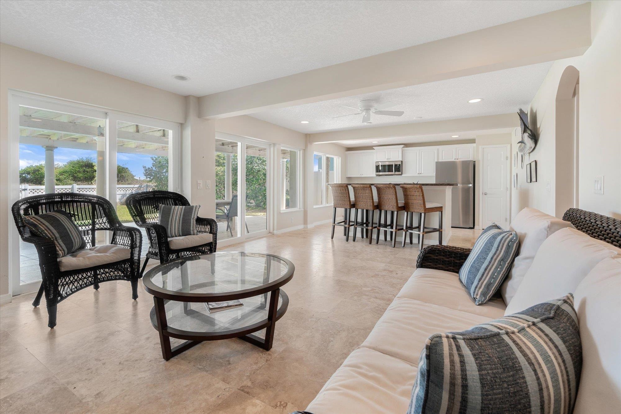 5512 Atlantic View St. Augustine, FL 32080 - Photo 37 of 77 Living area with a ceiling fan, arched walkways, a textured ceiling, beamed ceiling, and recessed lighting