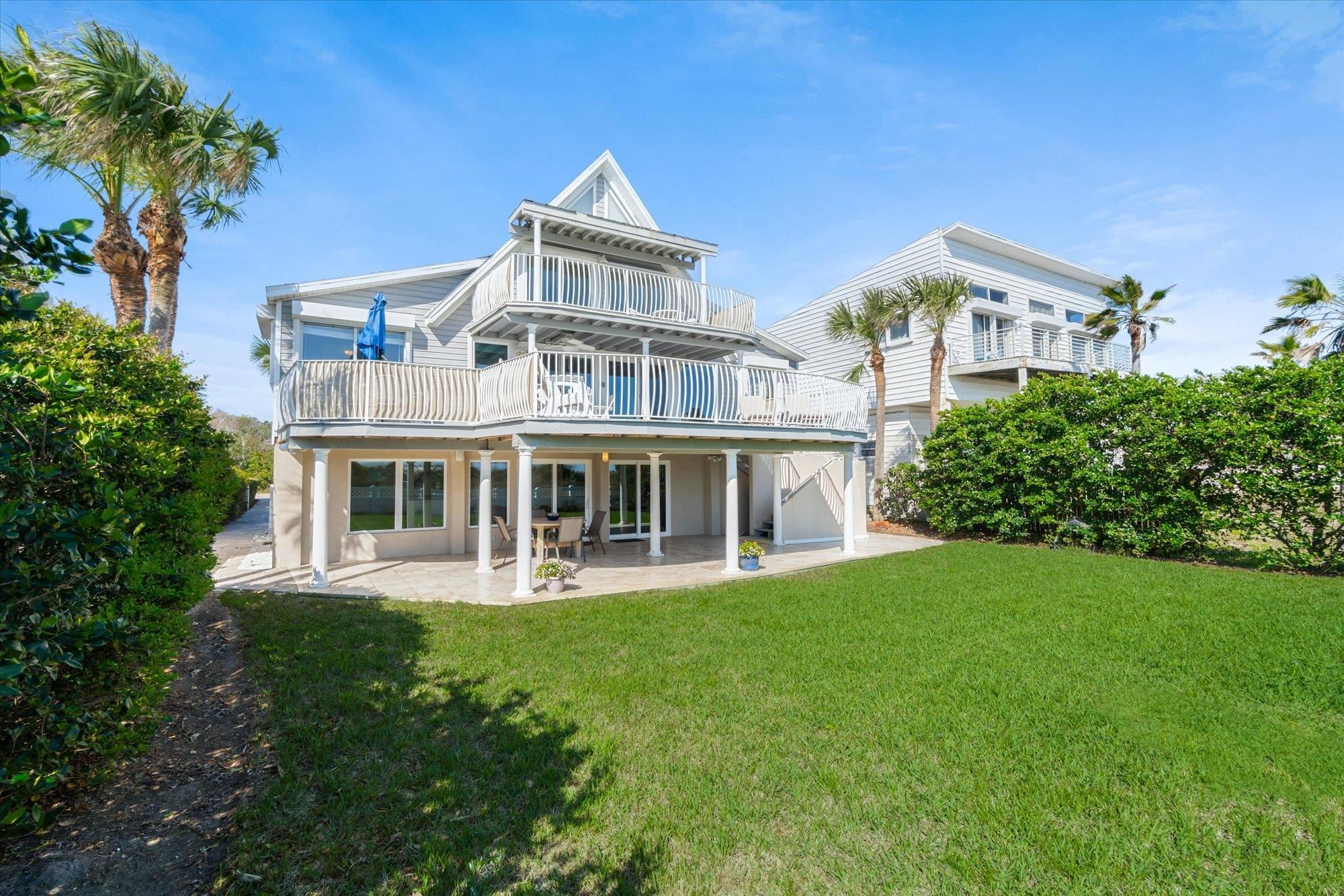 5512 Atlantic View St. Augustine, FL 32080 - Photo 47 of 77 Back of house featuring a patio area, a lawn, and a balcony