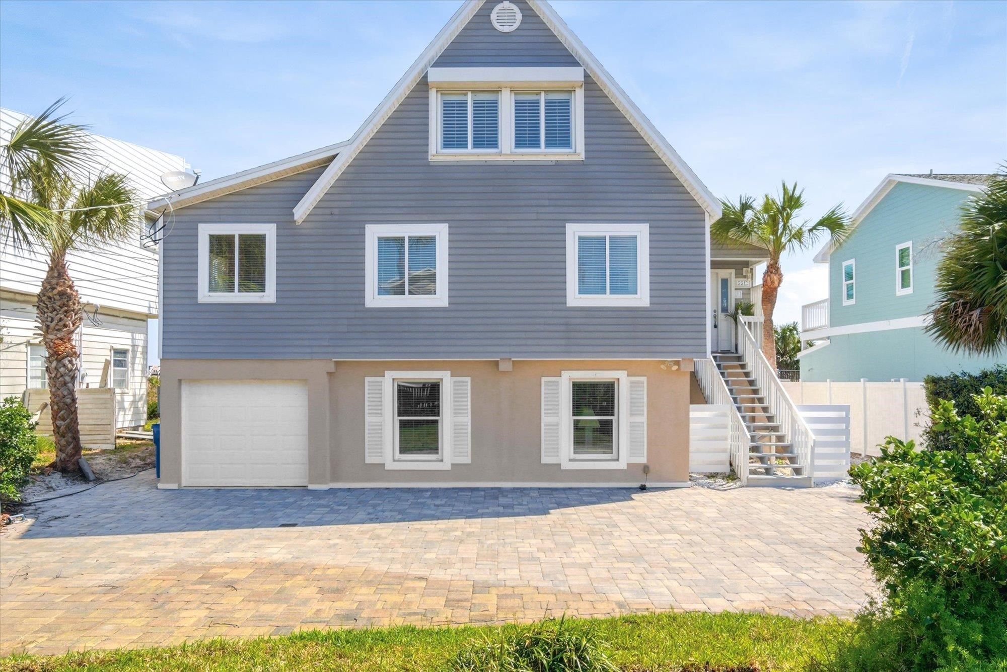5512 Atlantic View St. Augustine, FL 32080 - Photo 71 of 77 View of front of home featuring an attached garage, a patio area, and driveway