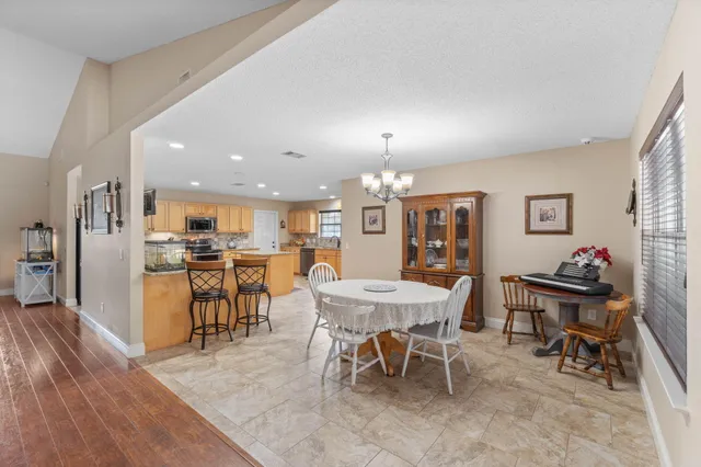 a kitchen with stainless steel appliances granite countertop a sink a cabinets and window