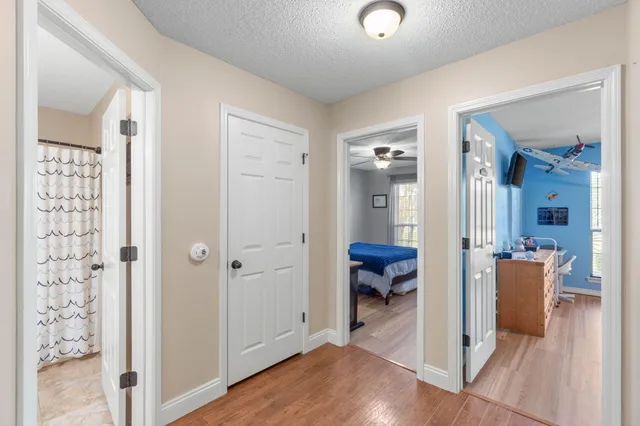 a bathroom with a granite countertop toilet a sink a mirror a shower curtain and a mirror