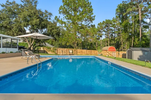 a swimming pool with outdoor seating