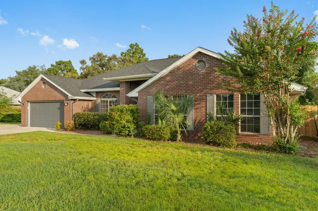 a view of a hallway with wooden floor and a living room