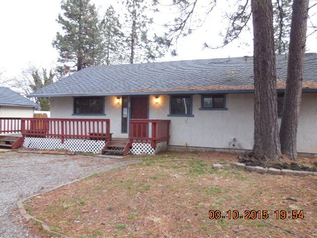 a view of a house with a yard and tree
