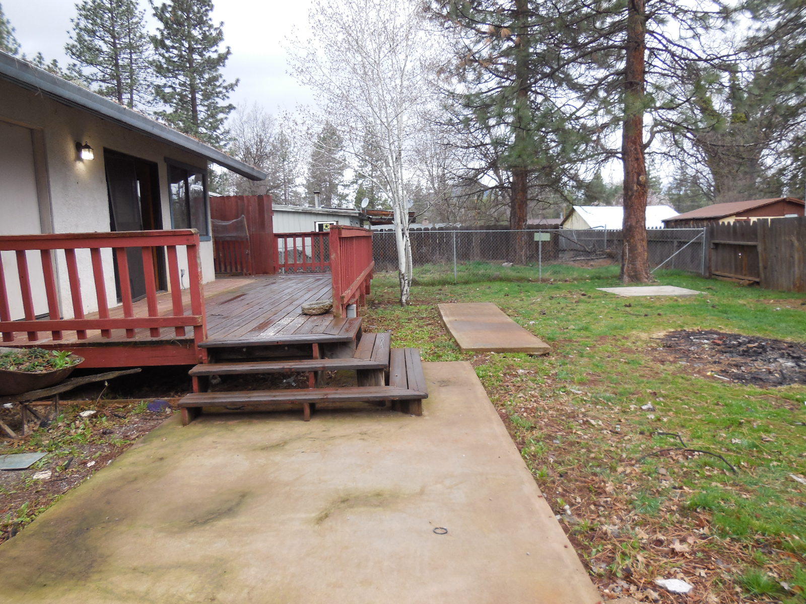 21729 2nd Street Burney, CA 96013 - Photo 14 of 26 a view of a backyard with wooden fence and a bench