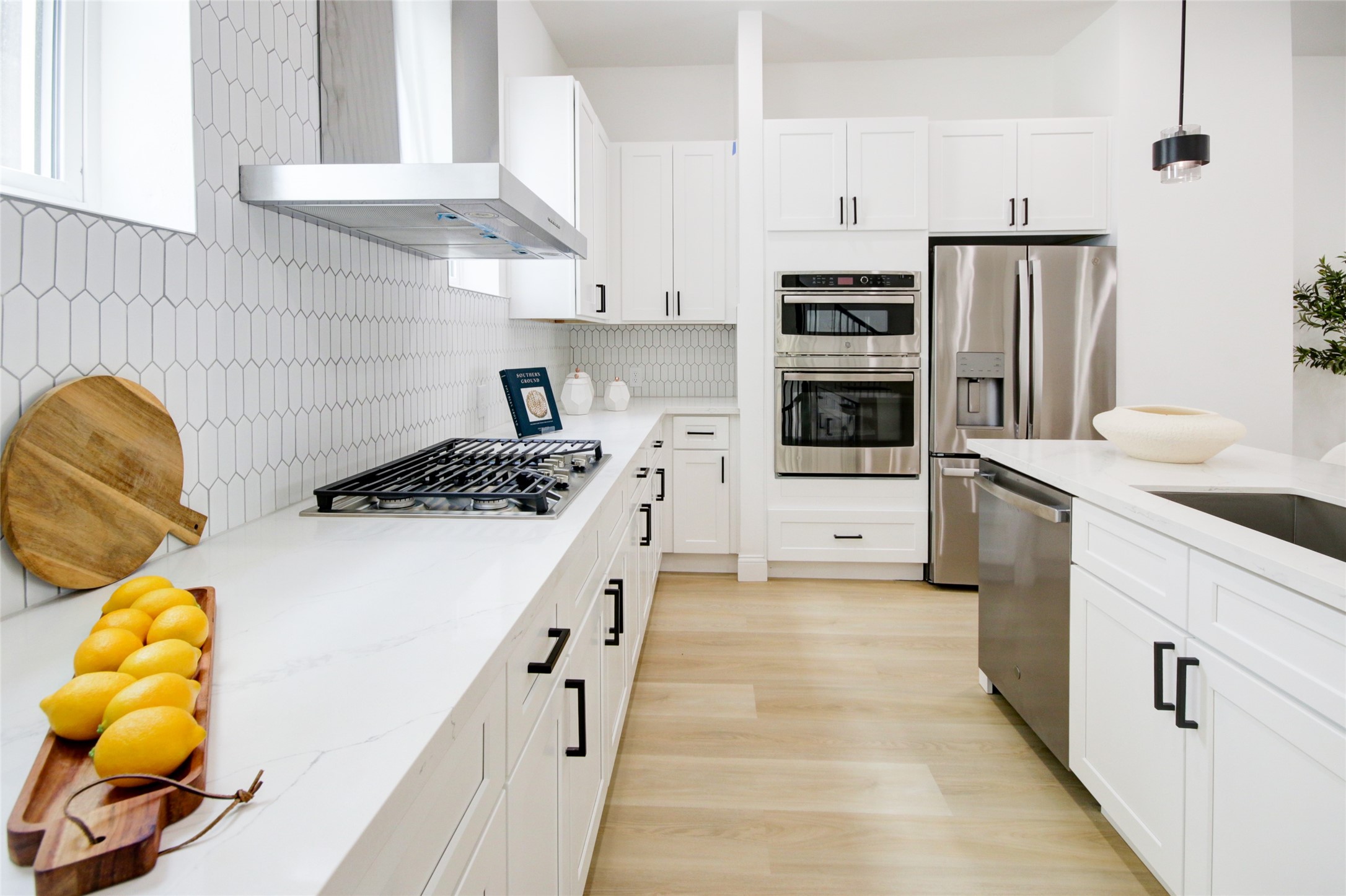 1214 West 24th Street, Unit D Houston, TX 77008 - Photo 11 of 45 a kitchen with stainless steel appliances a stove a sink and a refrigerator