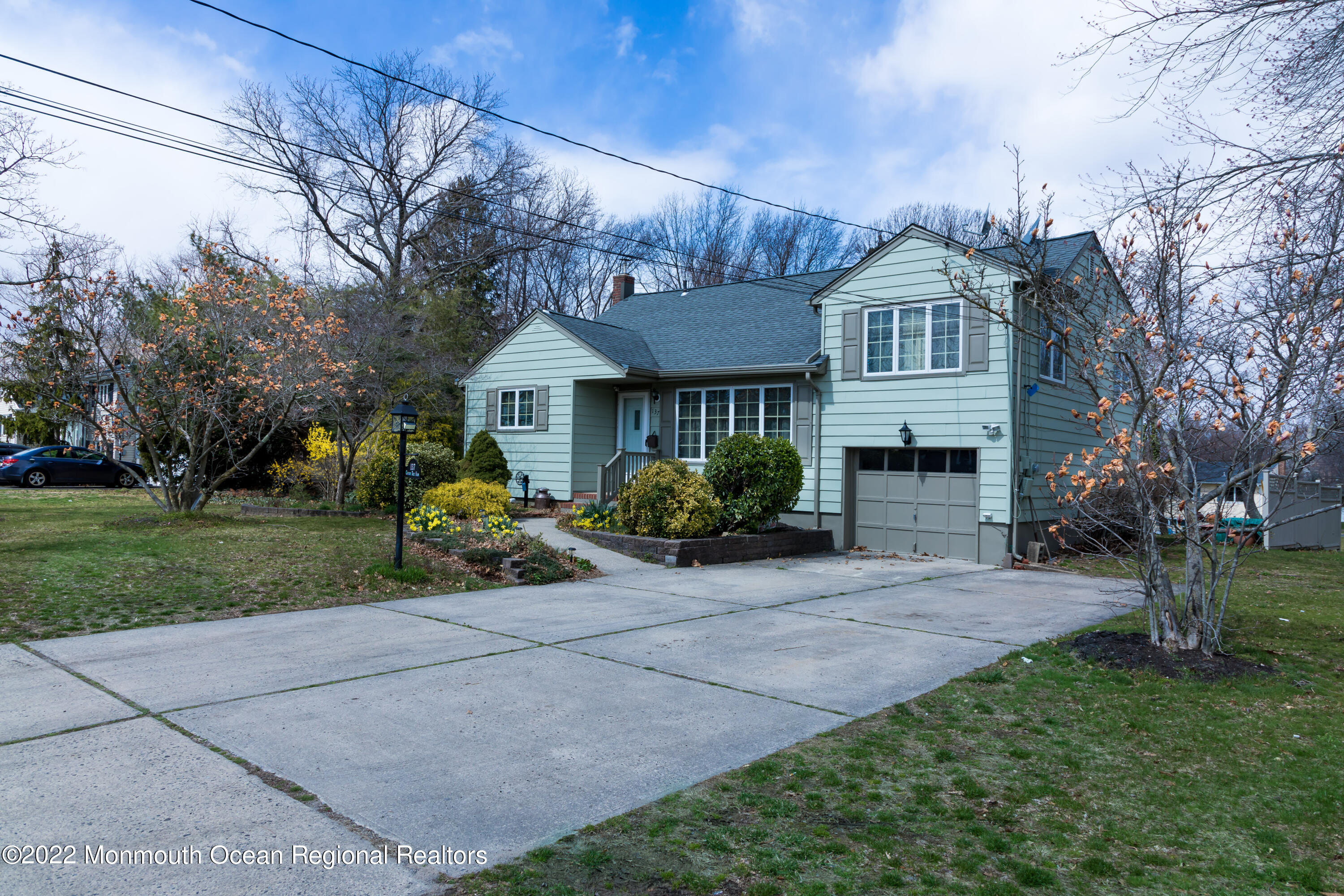 137 Cherry Tree Farm Road Middletown, NJ 07748 - Photo 36 of 36 a front view of a house with a garden and trees