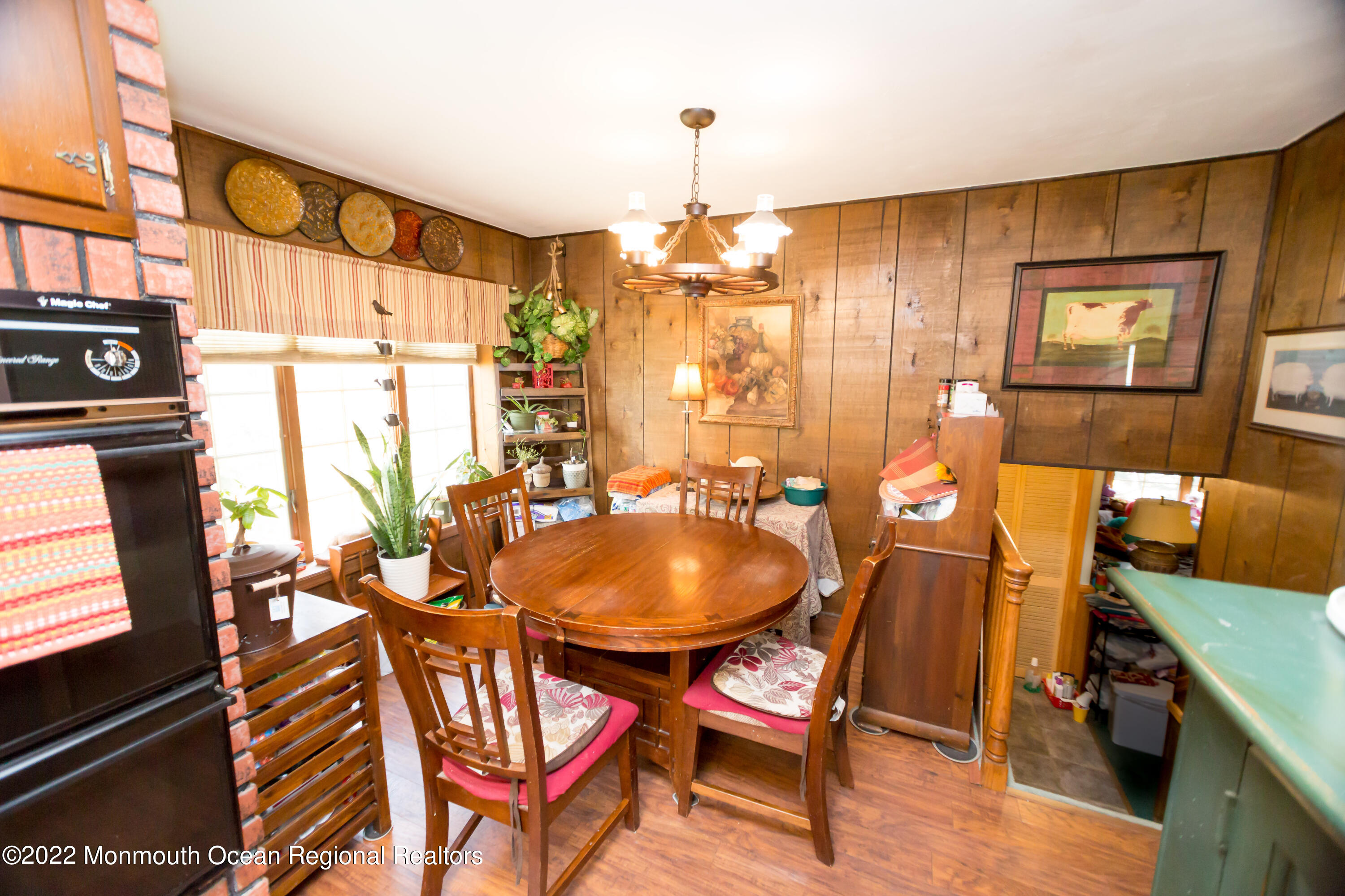 137 Cherry Tree Farm Road Middletown, NJ 07748 - Photo 8 of 36 a dining room with furniture a chandelier and wooden floor