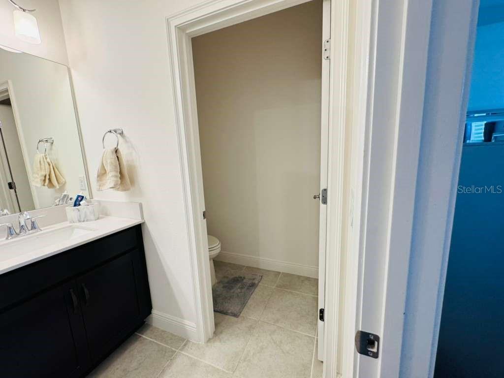 4913 Rain Shadow Drive St. Cloud, FL 34772 - Photo 15 of 22 a bathroom with a sink and a mirror