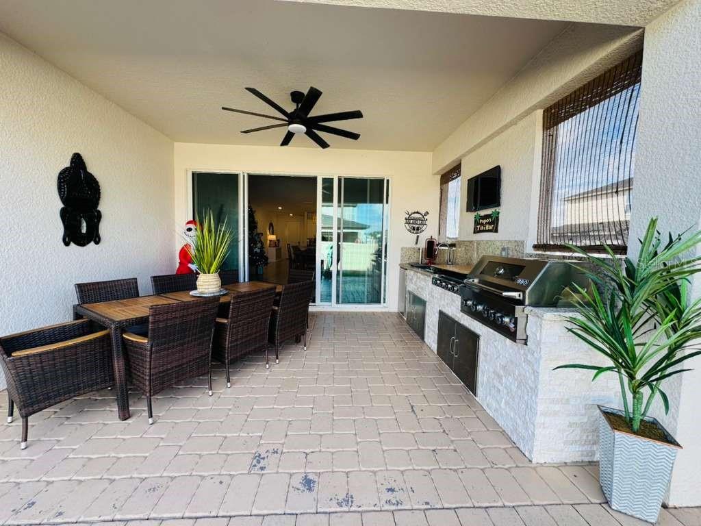 4913 Rain Shadow Drive St. Cloud, FL 34772 - Photo 20 of 22 a kitchen with a stove a sink and a microwave