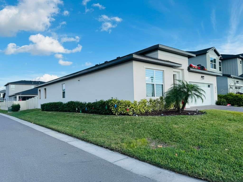 4913 Rain Shadow Drive St. Cloud, FL 34772 - Photo 2 of 22 a front view of a house with a yard and garage