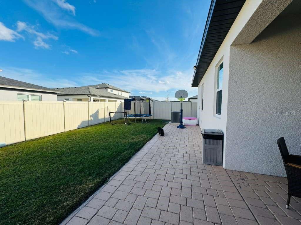 4913 Rain Shadow Drive St. Cloud, FL 34772 - Photo 21 of 22 a view of a patio with a yard