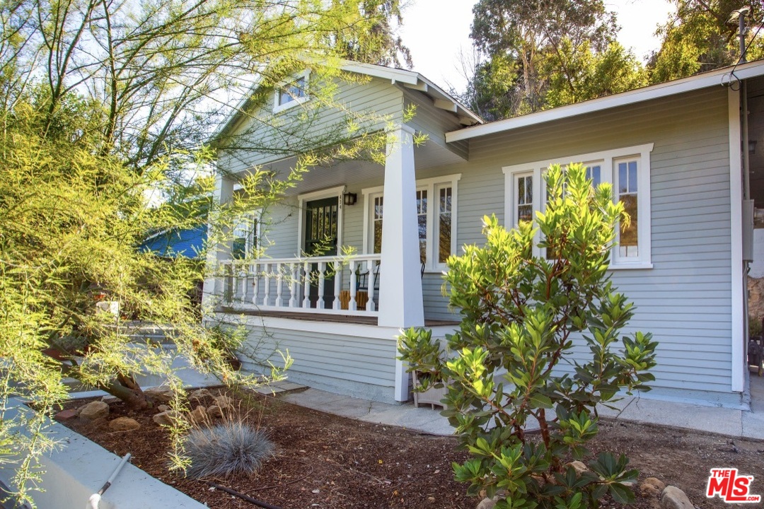 a view of a house with a flower garden