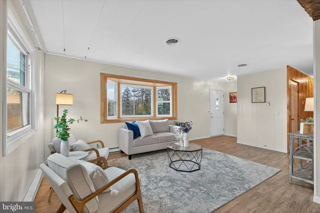 a living room with furniture and a chandelier