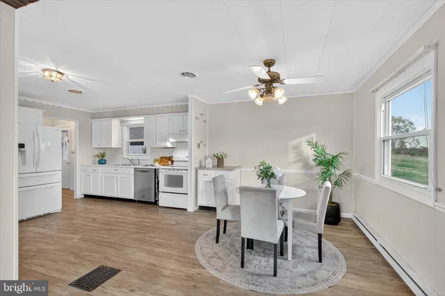 a view of a dining room with furniture and wooden floor