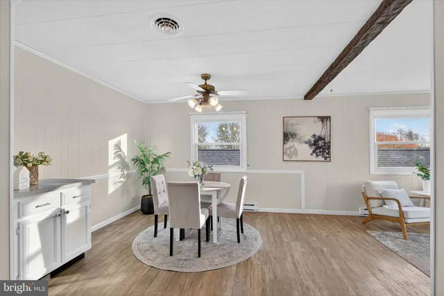 a dining room with furniture and wooden floor