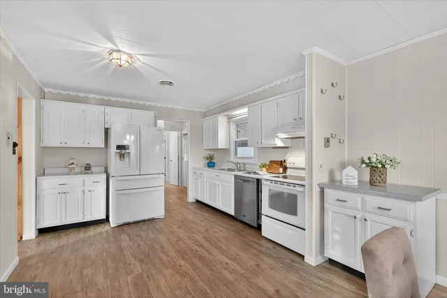 a kitchen with stove and white cabinets