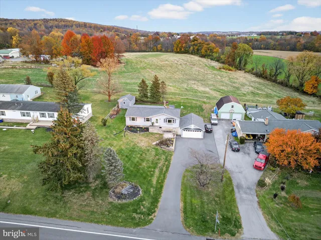 an aerial view of a house with outdoor space and lake view