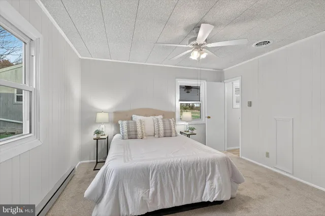 a bathroom with a sink a toilet a mirror and shower