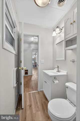 a bathroom with a granite countertop shower a toilet and a glass door shower