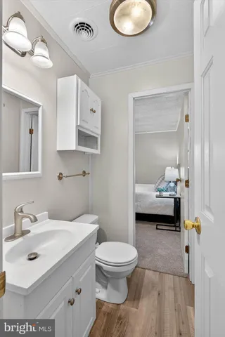 a bathroom with a sink shower and a mirror