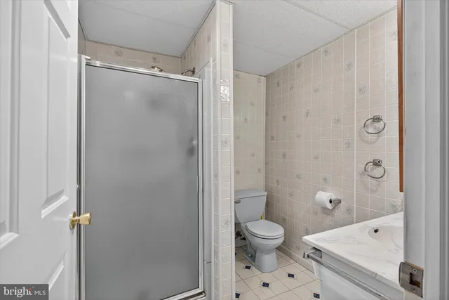 an empty room with closet and windows