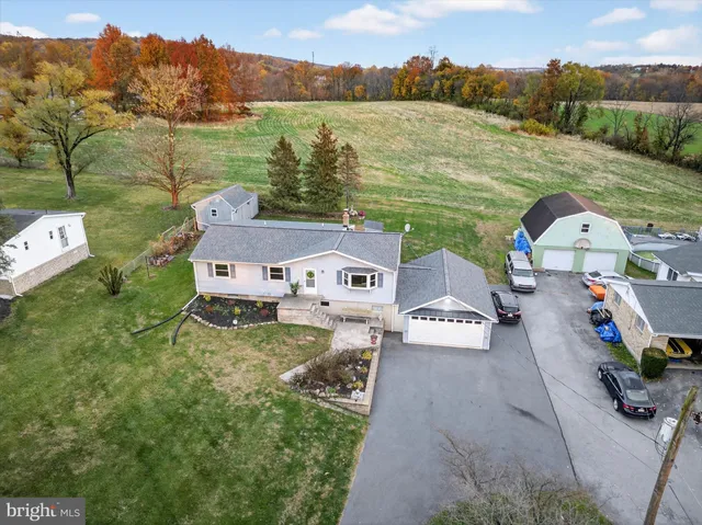 an aerial view of a house with outdoor space and lake view