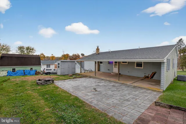 a backyard of a house with table and chairs