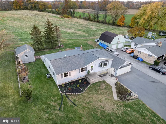 a view of a house with a yard and garage