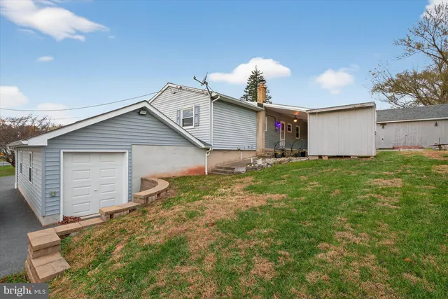 a view of a house with a big yard and potted plants