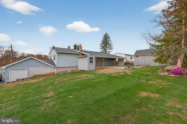 an aerial view of a house with garden space and street view